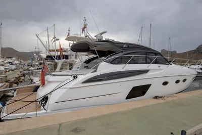 2017 Princess V48 Open yacht docked at a marina under cloudy skies.