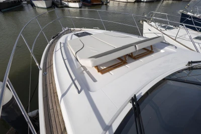Luxury 2018 Princess V50 yacht with sunbathing deck, docked in marina.