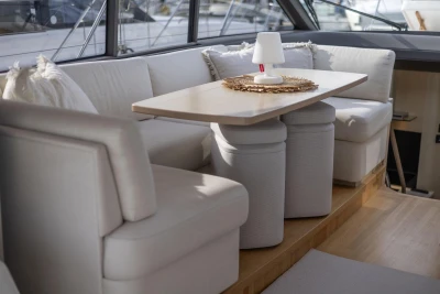 Luxurious interior of 2018 Princess V50 yacht with elegant seating and table setting.