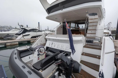 Luxury 2017 Princess 52 yacht docked, featuring elegant design and spacious deck area.