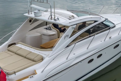 2006 Princess V48 yacht with sleek design and luxurious seating on calm water.