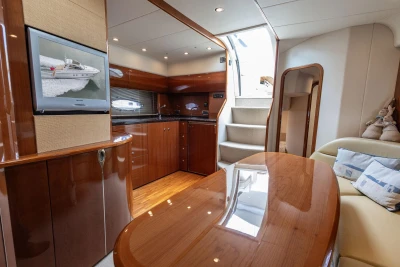 Luxurious interior of a 2006 Princess V48 yacht with polished wood finishes and modern amenities.