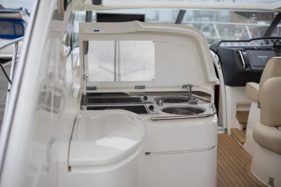 Interior view of 2006 Princess V48 yacht with kitchenette and helm station.