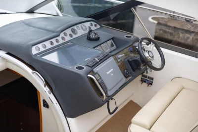 Helm of 2006 Princess V48 yacht with modern navigation equipment and luxurious seating.