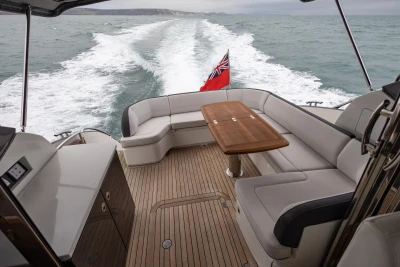 Luxurious 2014 Princess V48 yacht with elegant seating and wooden deck cruising at sea.