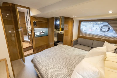 Luxurious interior of 2014 Princess V48 yacht with cozy bedroom and modern amenities.