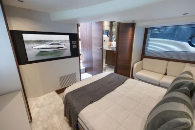 Luxurious interior of 2026 Princess V50 yacht with cozy bedroom and modern amenities.