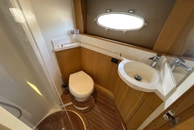 Luxurious 2012 Princess V42 yacht bathroom with wooden accents and modern fixtures.