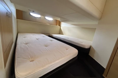 Twin beds in the cabin of a 2012 Princess V42 yacht.