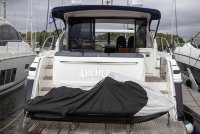 2012 Princess V52 yacht docked, rear view with covered equipment on deck.