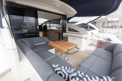 Luxury 2012 Princess V52 yacht with elegant seating and wooden table on deck.