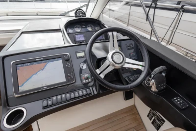 Helm of 2014 Princess V39 yacht with navigation system and steering wheel.