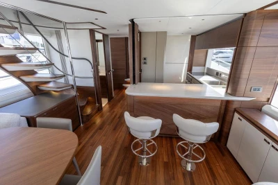 Luxurious interior of 2026 Princess X80 yacht with modern kitchen and elegant wood finishes.