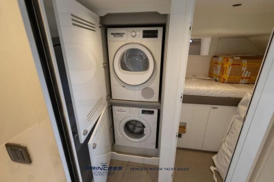 Laundry area in 2026 Princess X80 yacht with stacked washer and dryer.