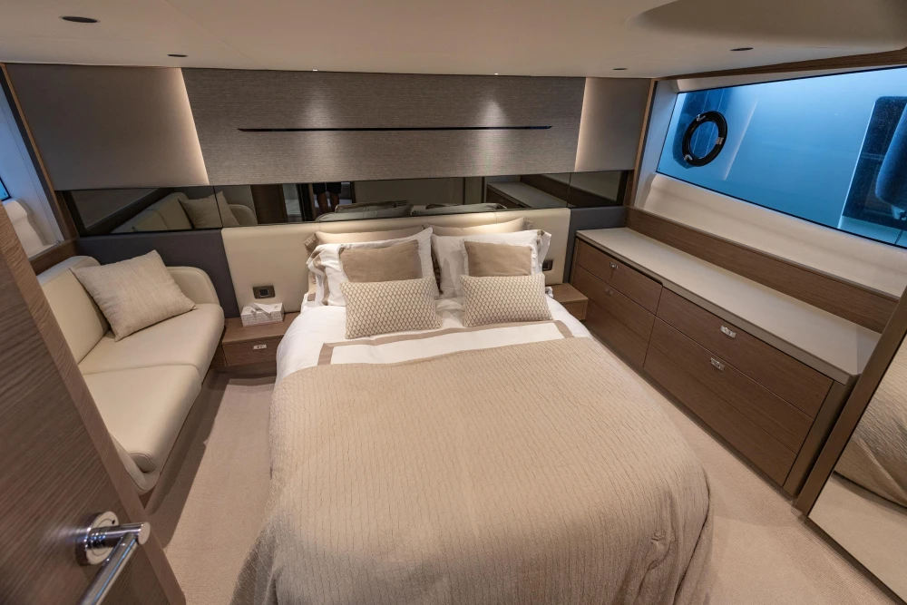 Luxurious bedroom interior of 2023 Princess V50 Open yacht, featuring elegant design and modern furnishings.