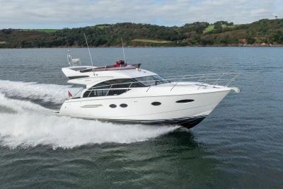 Luxury 2016 Princess 43 yacht cruising on open water.