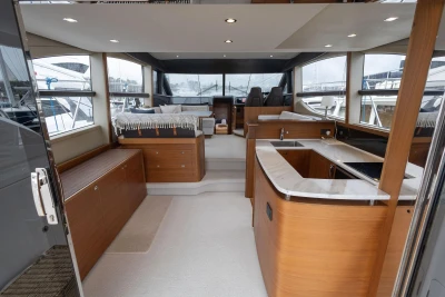 Luxurious interior of a 2017 Princess 52 yacht with modern kitchen and seating area.