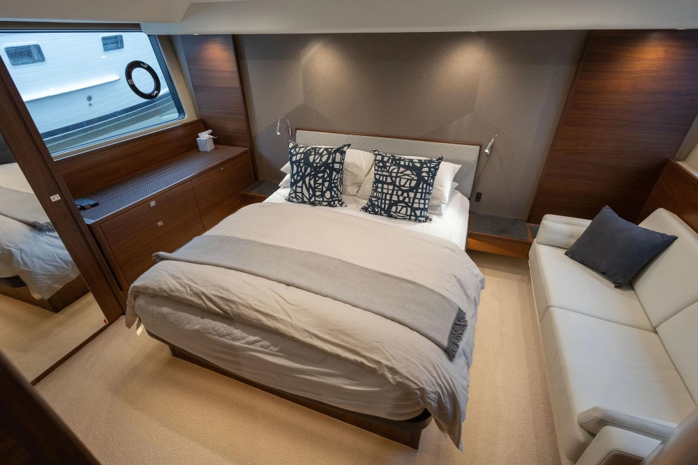 Luxurious bedroom interior of 2017 Princess 52 yacht with modern decor and cozy furnishings.