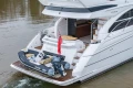 Luxury 2017 Princess 52 yacht with tender, cruising on calm waters.