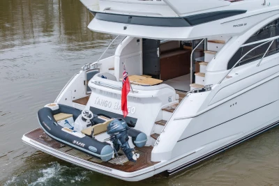 Luxury 2017 Princess 52 yacht with tender, cruising on calm waters.