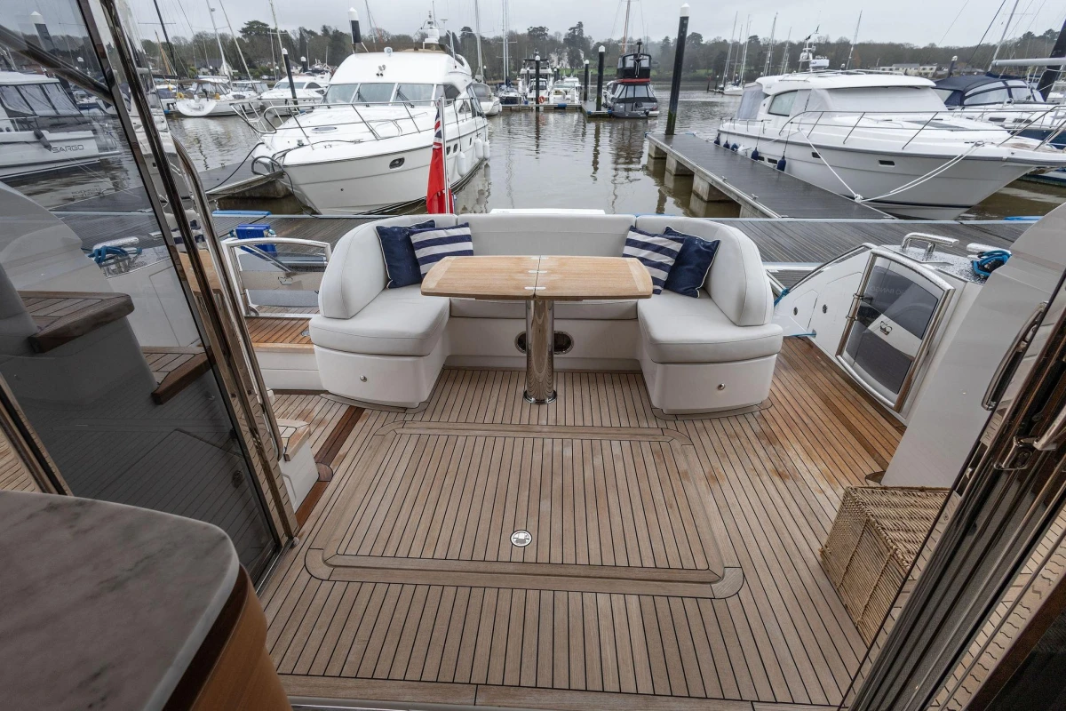 Luxurious 2017 Princess 52 yacht with elegant teak deck and comfortable seating area.