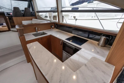 Luxurious 2017 Princess 52 yacht kitchen with marble countertops and modern appliances.