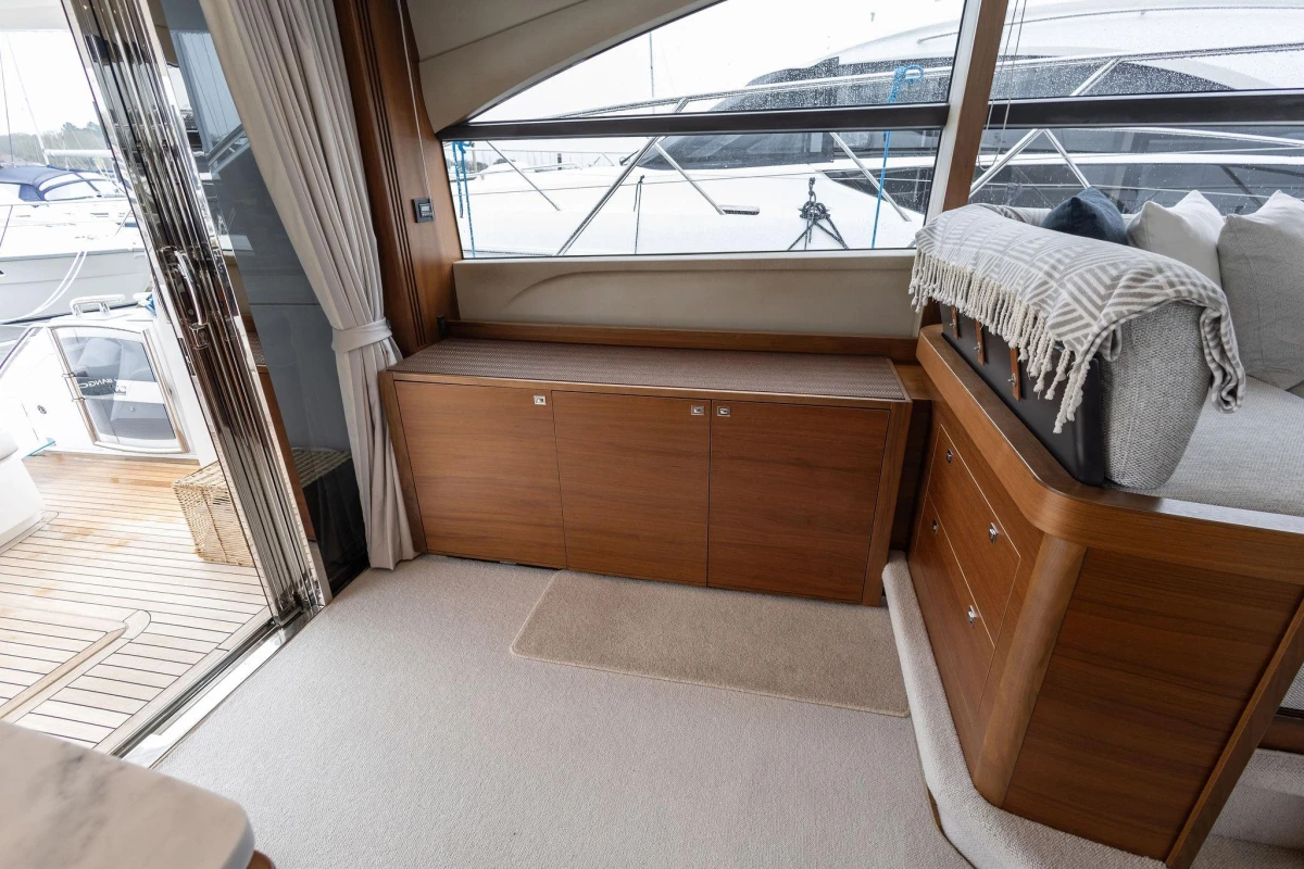 Luxurious interior of 2017 Princess 52 yacht with wooden cabinetry and plush seating.