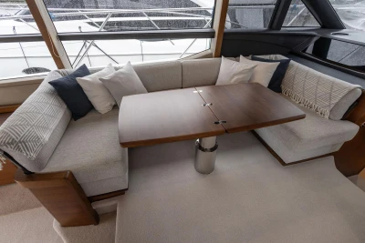 Luxurious interior of 2017 Princess 52 yacht with elegant seating and wooden table.