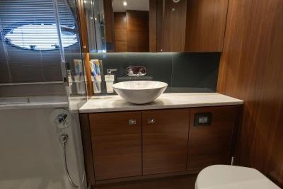 Luxurious bathroom interior of 2017 Princess 52 yacht with modern fixtures and wood accents.