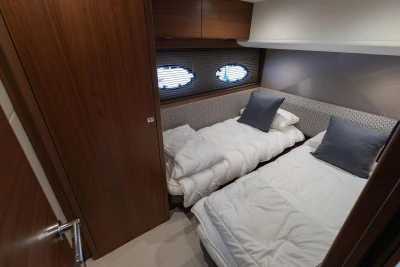 Luxurious twin cabin interior of 2017 Princess 52 yacht with elegant bedding.