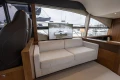 Luxurious interior of 2017 Princess 52 yacht with sofa and marina view.