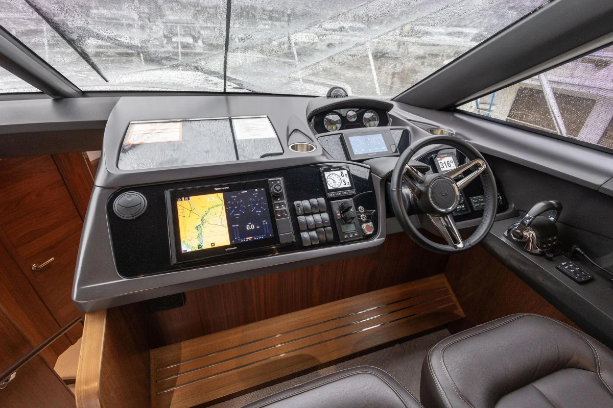 Cockpit of 2017 Princess 52 yacht with modern navigation controls and leather seating.