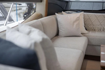 Luxurious interior of 2017 Princess 52 yacht with elegant beige seating and cushions.