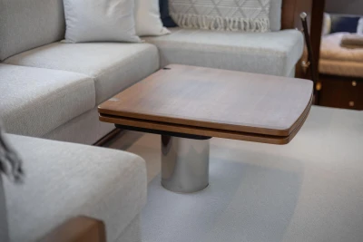 Luxurious interior of 2017 Princess 52 yacht with elegant wooden table and plush seating.