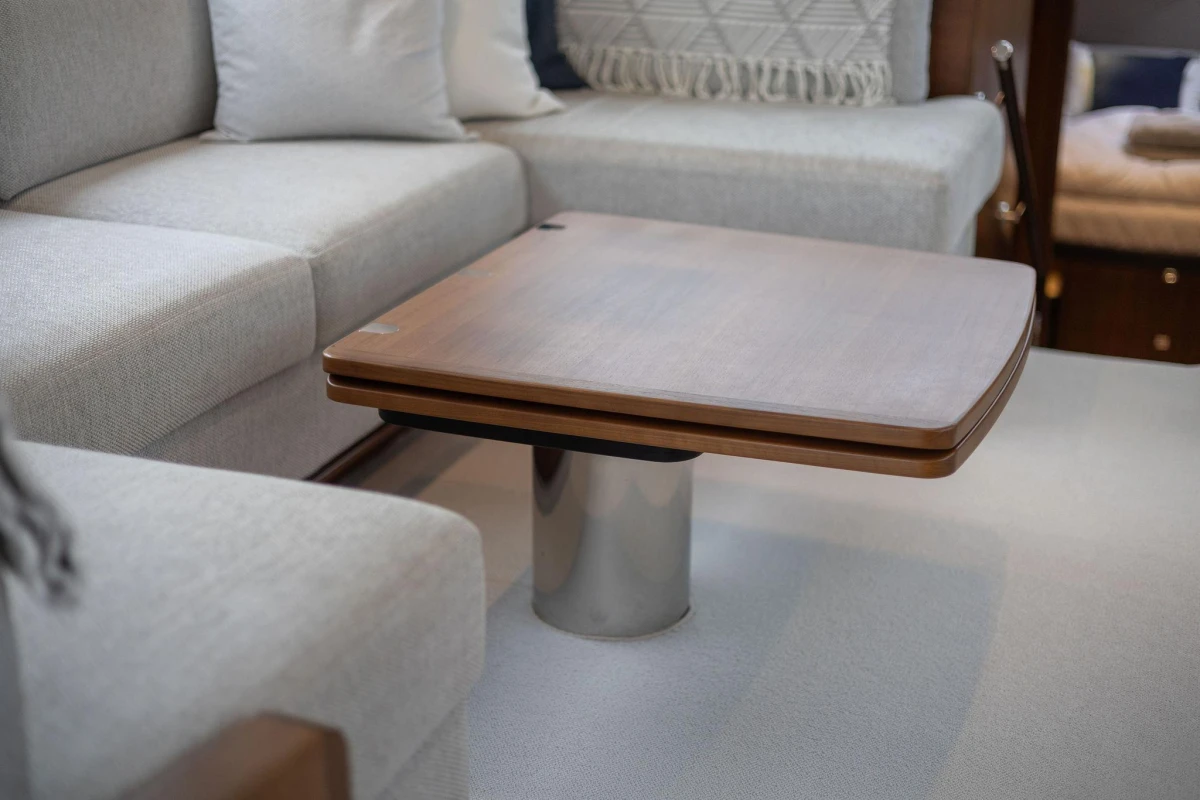 Luxurious interior of 2017 Princess 52 yacht with elegant wooden table and plush seating.