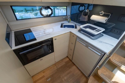 Modern kitchen in 2017 Princess V40 yacht with stove, sink, and microwave.