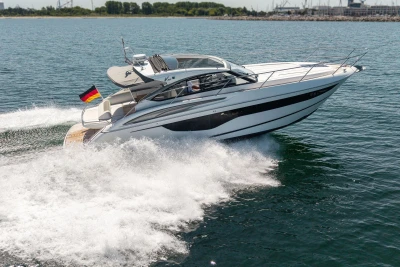 2017 Princess V40 yacht cruising on open water with German flag.