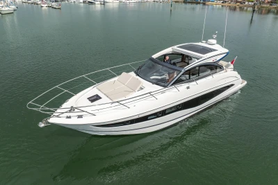 2025 Princess V50 yacht cruising on calm waters, showcasing sleek design and luxury features.