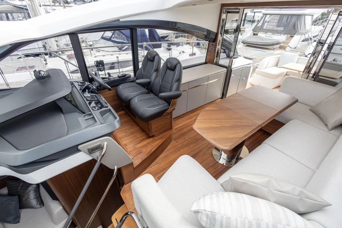 Luxurious interior of 2025 Princess V50 yacht with modern seating and wooden accents.