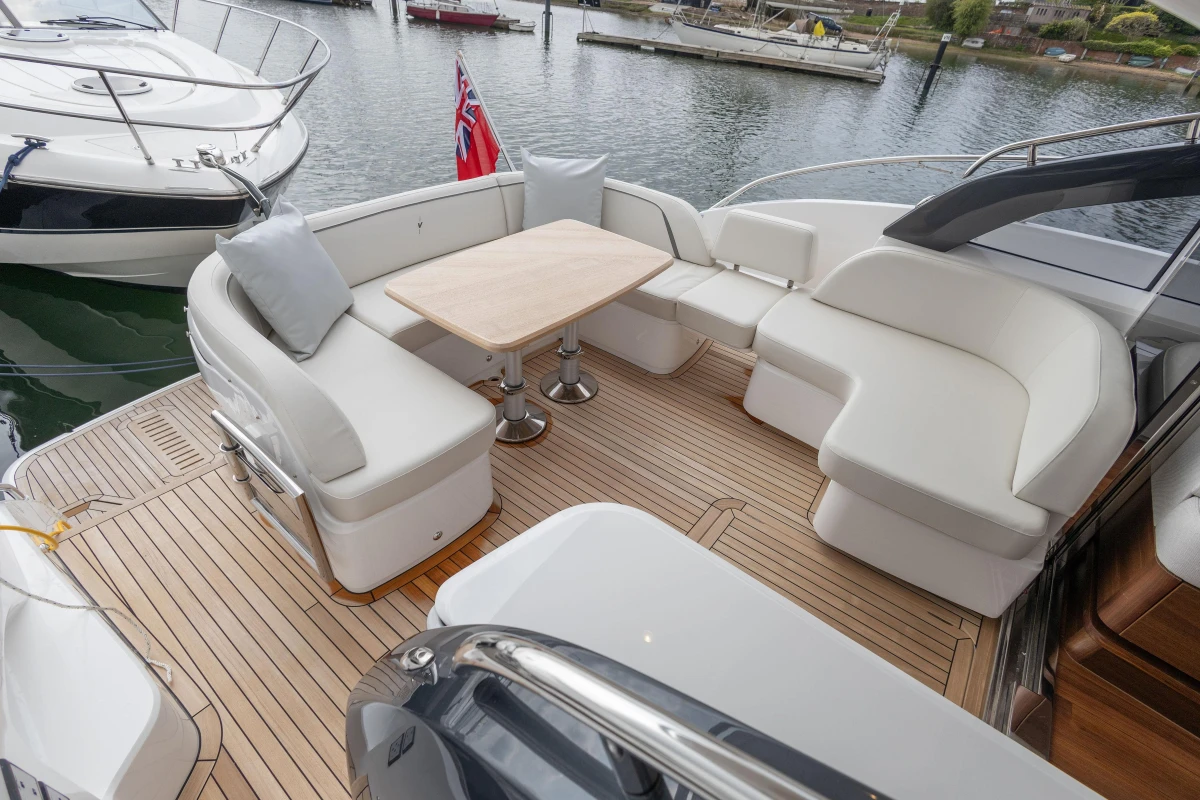 Luxury seating area on 2025 Princess V50 yacht with elegant wooden deck.