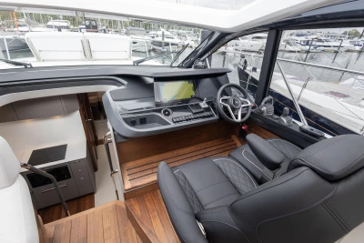 Luxurious 2025 Princess V50 yacht interior with modern helm and leather seating.