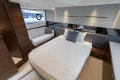 Luxurious 2025 Princess V50 yacht bedroom with modern design and elegant furnishings.