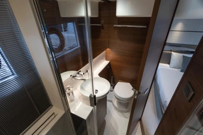 Luxurious bathroom interior of 2025 Princess V50 yacht, featuring modern fixtures and elegant wood finishes.