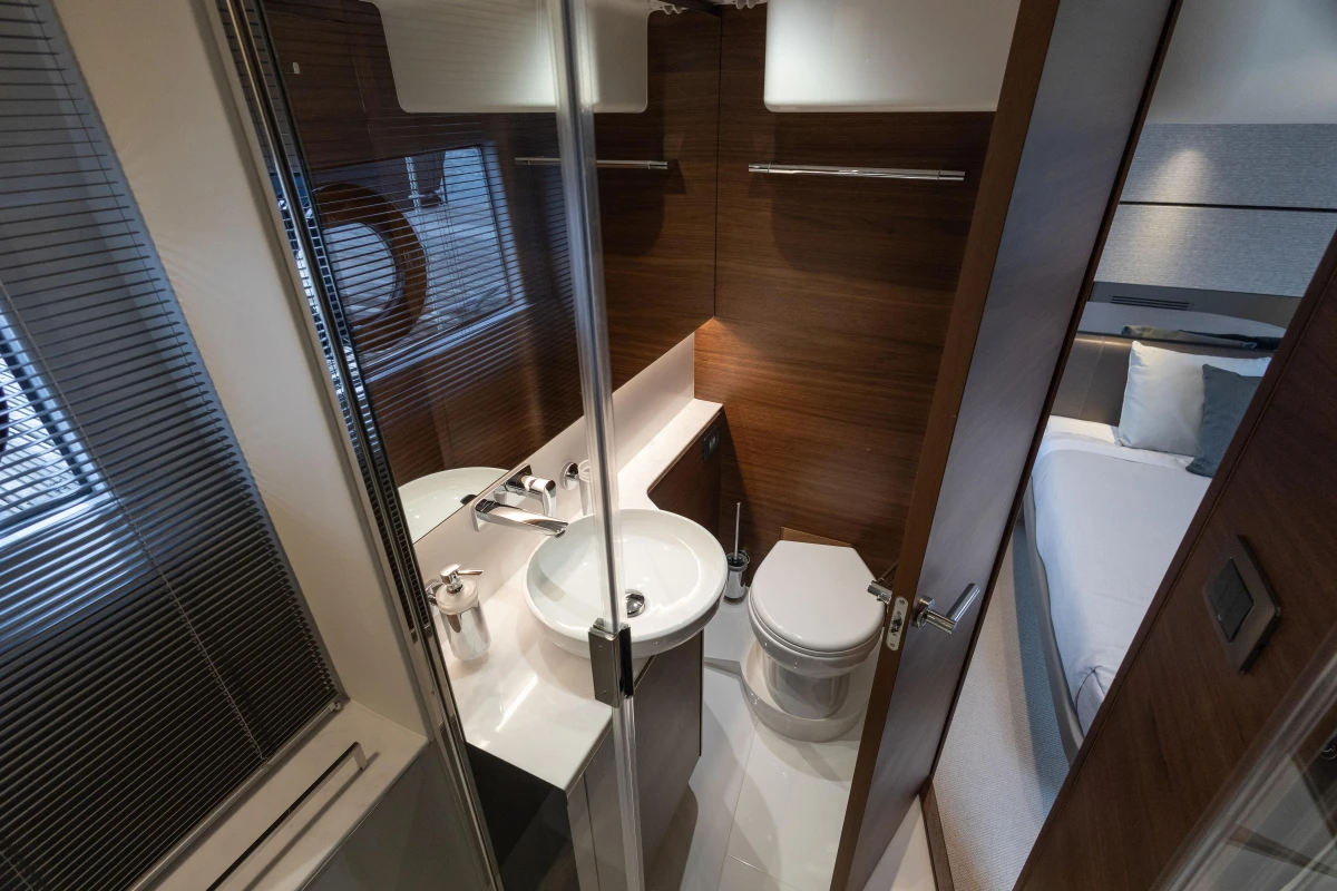 Luxurious bathroom interior of 2025 Princess V50 yacht, featuring modern fixtures and elegant wood finishes.