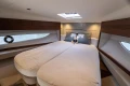 Luxurious cabin interior of 2025 Princess V50 yacht with plush bedding and elegant design.