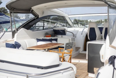 Luxurious 2015 Princess V39 yacht interior with seating and wooden table.