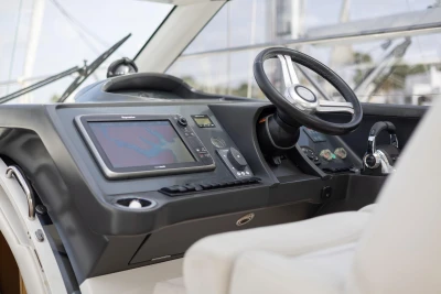 Helm of 2015 Princess V39 yacht featuring modern navigation controls and steering wheel.