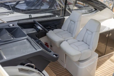 Interior of 2015 Princess V39 yacht with dual white captain seats and control panel.