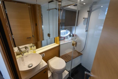 Luxurious bathroom interior of 2015 Princess V39 yacht with modern fixtures and wooden accents.