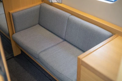 Gray sofa in 2015 Princess V39 yacht interior, featuring light wood accents.